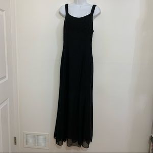 Long black dress by Reggio is in excellent condition. Size 6